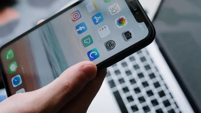 Smartphone apps shown beside a laptop for IPTV player setup